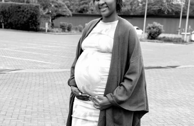 Pregnant woman smiling outdoors, symbolizing maternal health, strength, and support for mothers through Sebineza Care Organization.